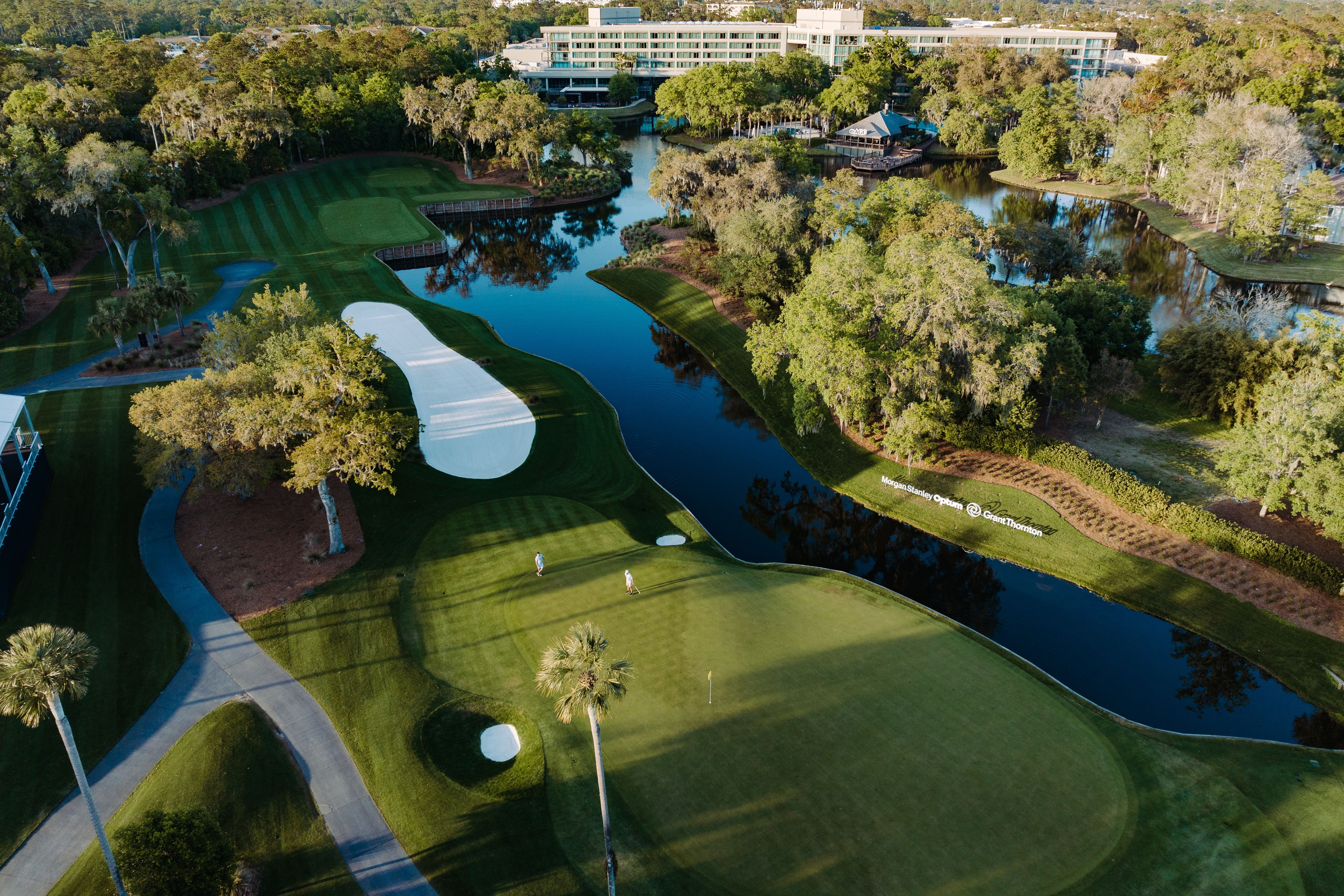 Aerial view of TPC Sawgrass golf course, showing the iconic island green surrounded by water, fairways, and lush landscaping
