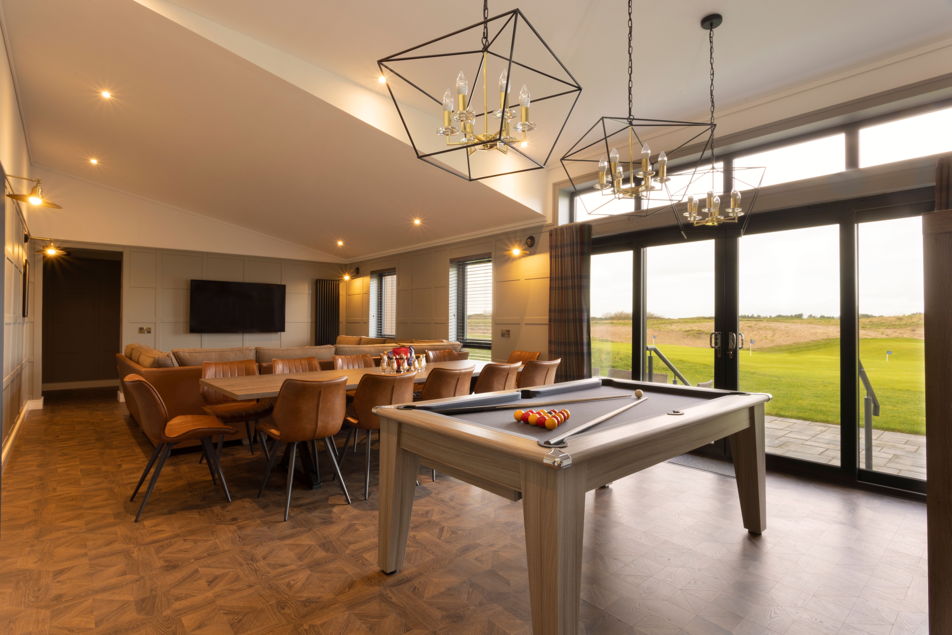 Interior view of Dundonald Link Lodges surrounded by greenery, featuring modern wooden lodge buildings in a peaceful holiday setting