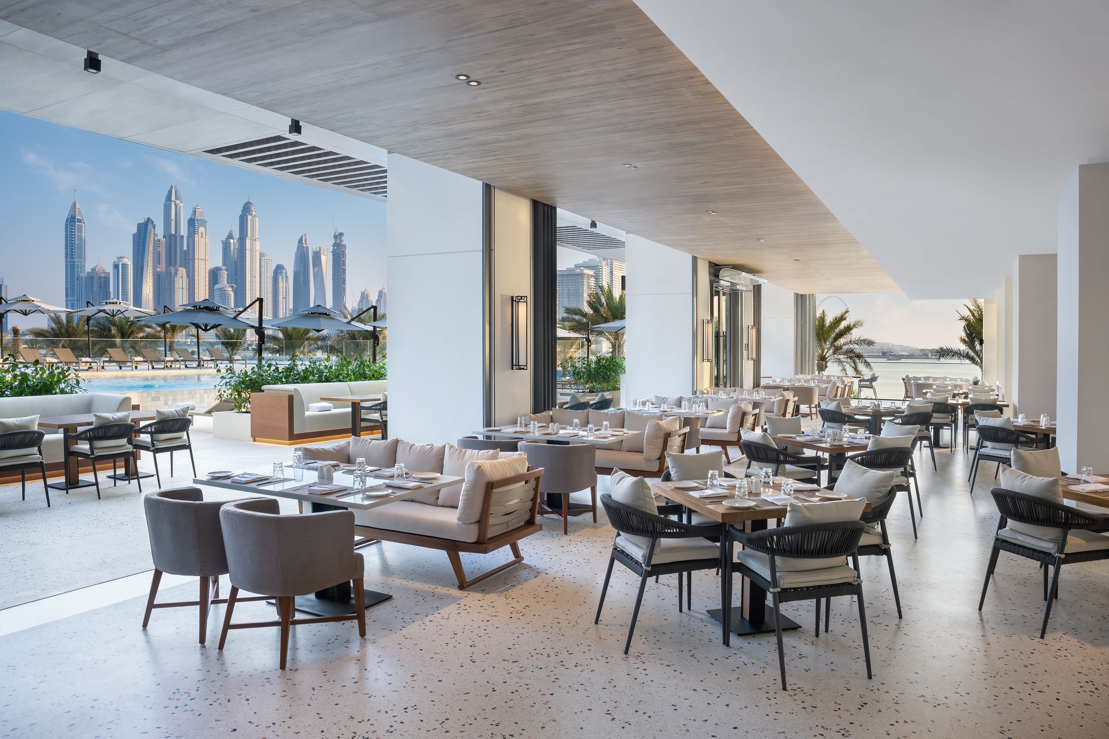 Dining area inside Radisson Hotel restaurant with neatly set tables, modern decor, and warm ambient lighting