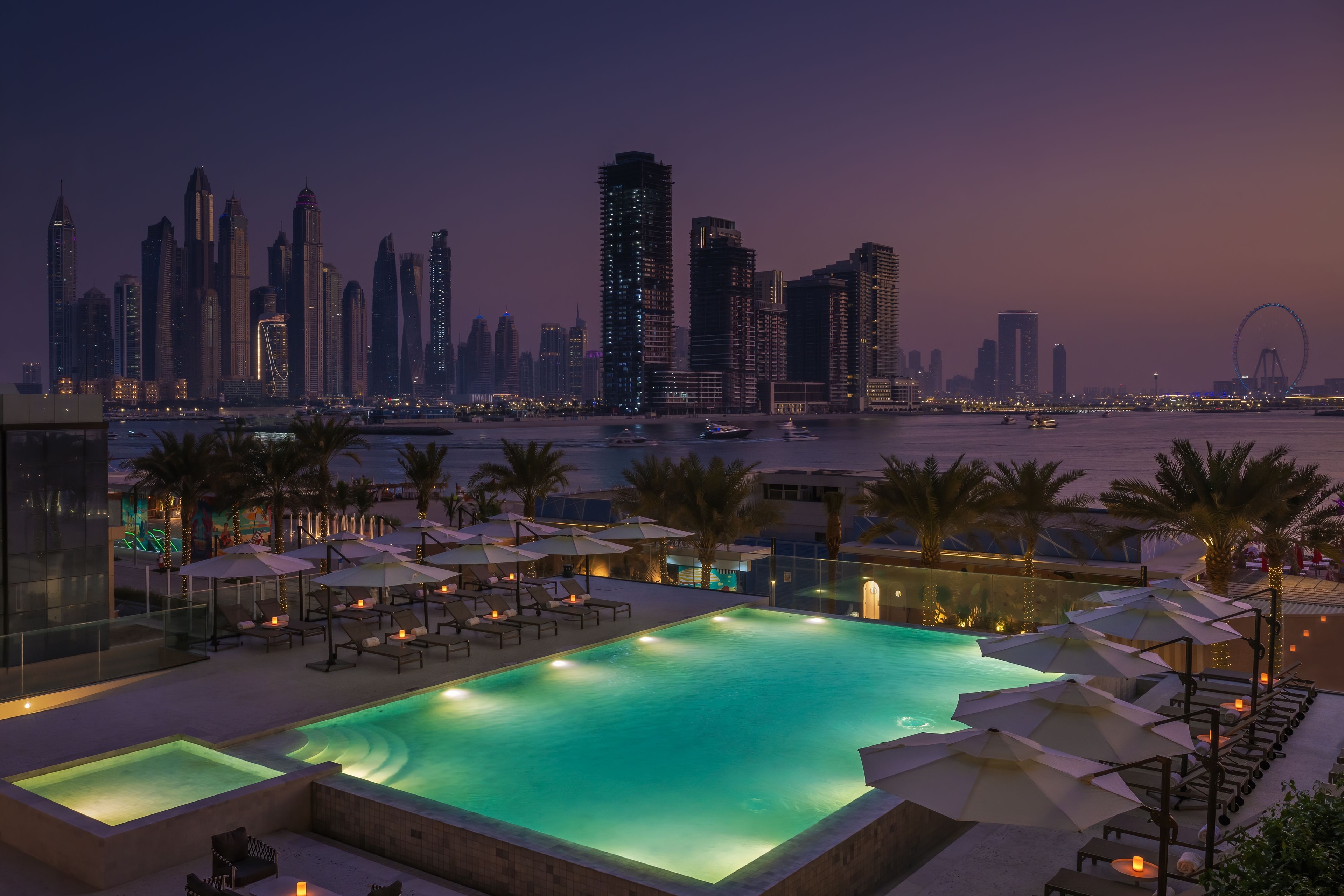 Outdoor Radisson hotel pool with clear blue water, lounge chairs, and surrounding hotel building under a bright sky